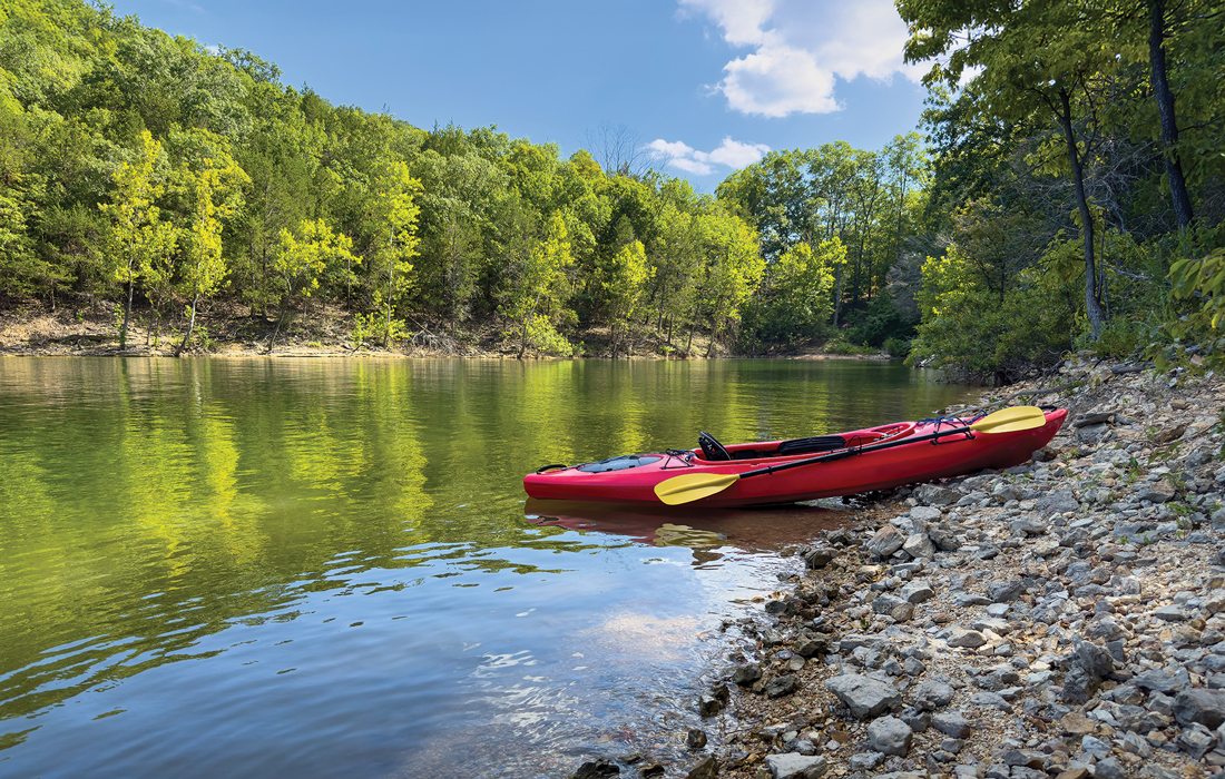 Red kayak resting on the rocky shore of Mill Creek Lake