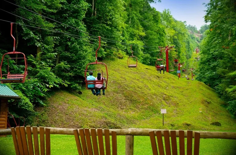 Couple riding the red sky lift up the cliffside at Natural Bridge