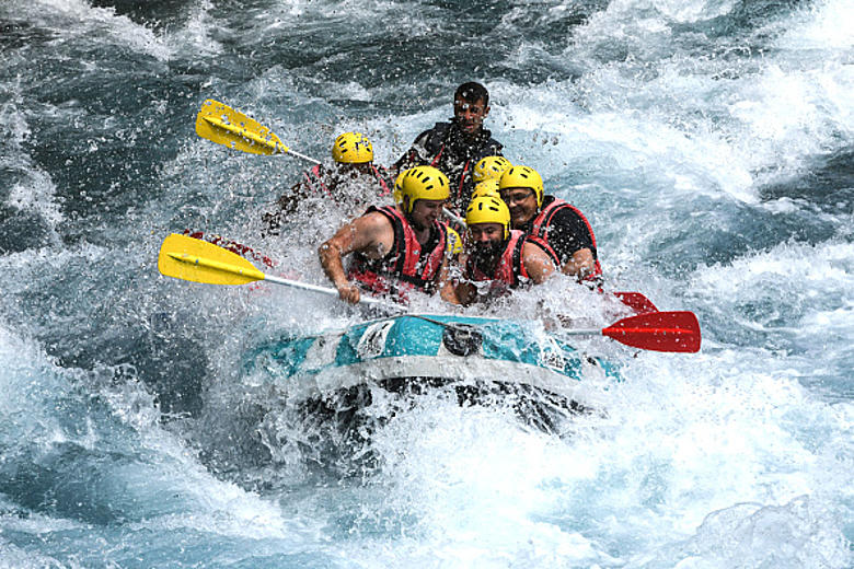 Whitewater raft punching through big rapids